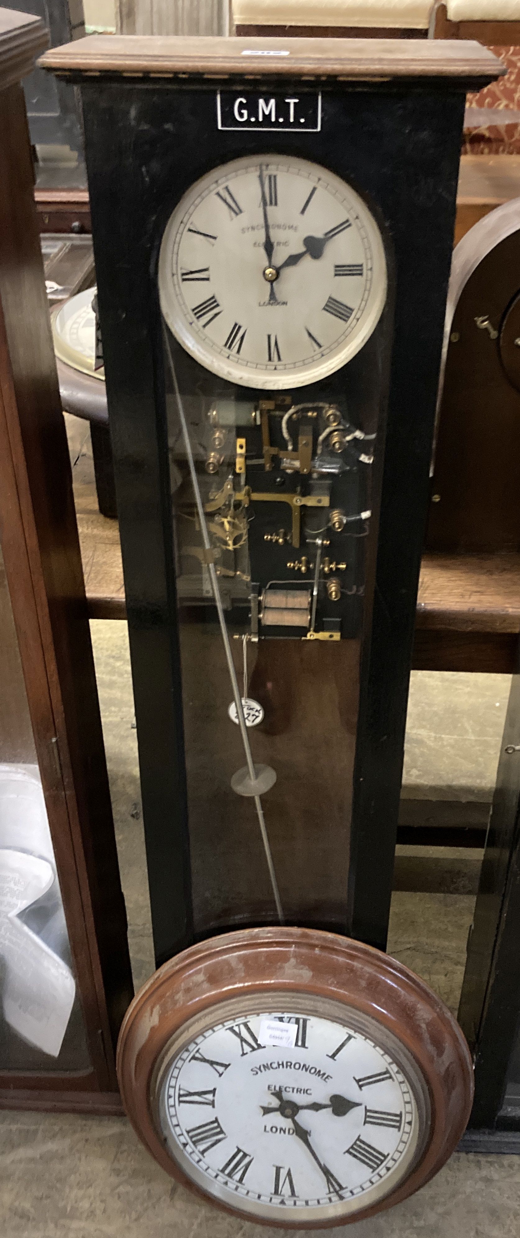 A Synchronome electric oak cased pendulum master clock, height 128cm and a Synchronome electric painted metal circular slave clock